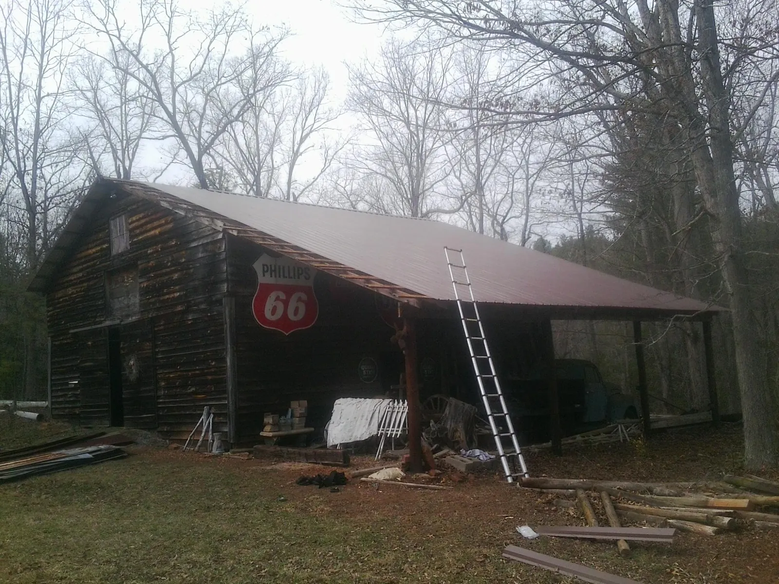 New metal roof on an open sided timber barn with a vintage sign in Richland
